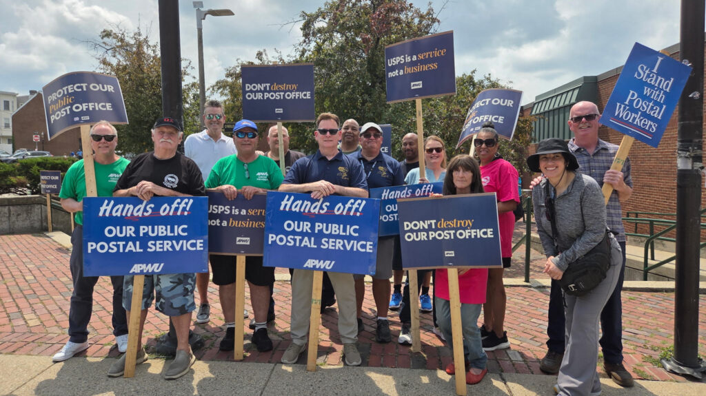 Members of the Boston area locals line up holding signs